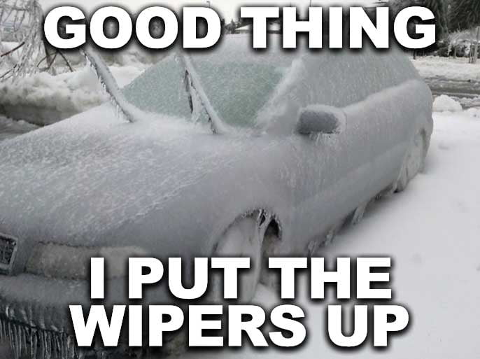 The image depicts a car completely covered in heavy snow and ice, with the windshield wipers visibly raised. Overlaid text at the top reads 'GOOD THING' and at the bottom reads 'I PUT THE WIPERS UP,' creating a humorous contrast. The meme playfully highlights the irony of a common winter preparation tip (raising wipers to prevent freezing) being rendered ineffective by the sheer amount of snow, resulting in a relatable and funny scenario for those familiar with winter weather struggles.