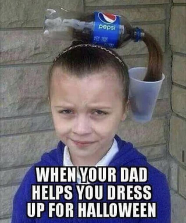 A photograph of a child with a comically haphazard Halloween costume hairstyle, featuring a blue Pepsi plastic bottle and a clear plastic cup attached to their hair. The child has a neutral-to-slightly-unamused expression, wearing a blue hoodie over a white shirt. The background consists of a stone wall. Prominent white text overlay at the bottom reads: 'WHEN YOUR DAD HELPS YOU DRESS UP FOR HALLOWEEN,' emphasizing the humorous scenario of a father's well-meaning but chaotic Halloween costume assistance.