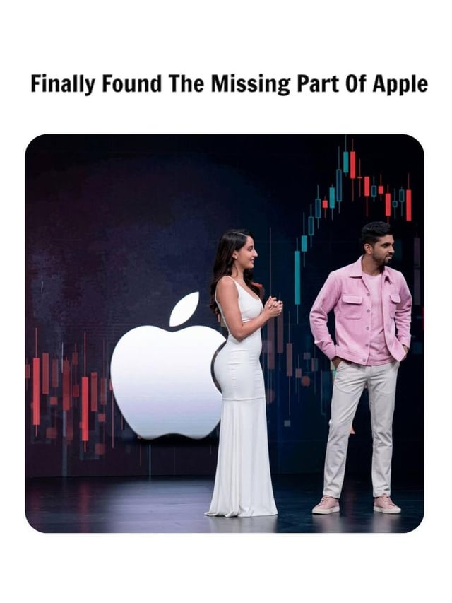 This meme uses a forced visual alignment joke: a woman wearing a form-fitting white dress is positioned standing in front of a large Apple logo, so that the curve of her back and hip perfectly fills the missing 'bite' indentation on the right side of the Apple logo. A man in a pink jacket and light pants stands to her right, looking off to the side, with a background of stock market candlestick charts behind both people. The text at the top of the meme reads 'Finally Found The Missing Part Of Apple', making a joke that the woman's body shape is the piece that was 'missing' from the Apple logo design.
