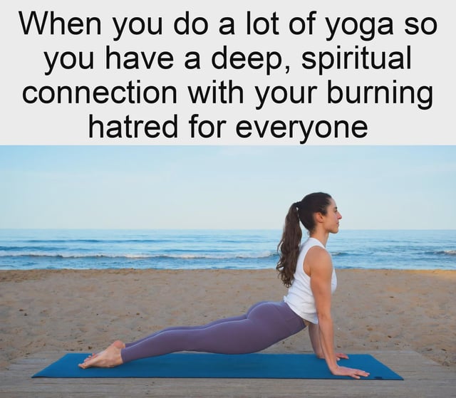 The image is a humorous meme consisting of two main parts: a top text panel and a lower photograph. The text reads: 'When you do a lot of yoga so you have a deep, spiritual connection with your burning hatred for everyone.' Below the text is a photograph of a woman practicing yoga on a beach. She is positioned on a blue yoga mat, wearing a white tank top and purple leggings, performing a pose that resembles a low plank or cobra (hands on the mat, body elevated, legs extended behind). The background features a calm ocean with gentle waves and a clear sky, creating a serene, peaceful atmosphere. The humor arises from the stark contrast between the tranquil yoga scene and the sarcastic text, which subverts the typical association of yoga with inner peace and spirituality by replacing it with a comedic focus on 'burning hatred for everyone.'