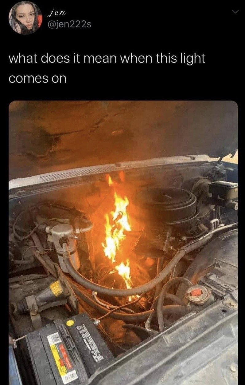 This is a screenshot of a social media post on X (formerly Twitter). The poster asks the question 'what does it mean when this light comes on' above an image of an open car hood with the internal car engine visibly engulfed in flames. The humor comes from the extreme understatement: the poster refers to a severe, obvious, catastrophic car failure (engine fire) as if it were a minor, standard dashboard warning light, mocking people with little automotive knowledge who ask obvious questions about major car issues.