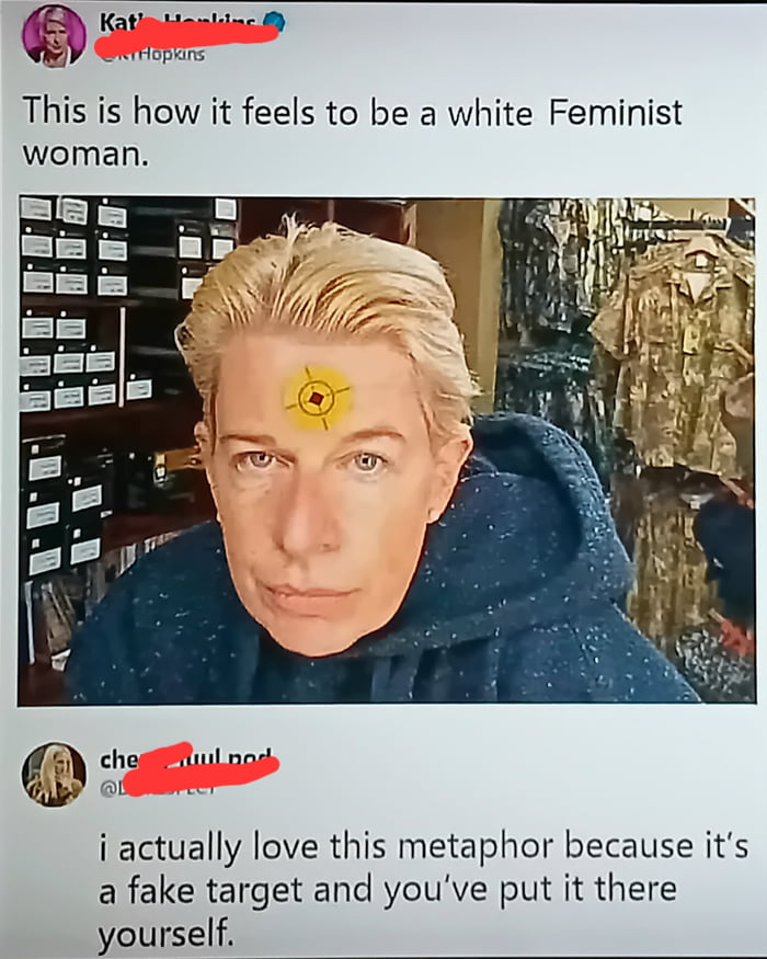 A social media post featuring an image of a person with a yellow target symbol edited onto their forehead. The post is captioned 'This is how it feels to be a white Feminist woman.' and includes a reply that says 'i actually love this metaphor because it's a fake target and you've put it there yourself.' The person is wearing a blue hoodie and appears to be in a store with military-style clothing visible in the background.