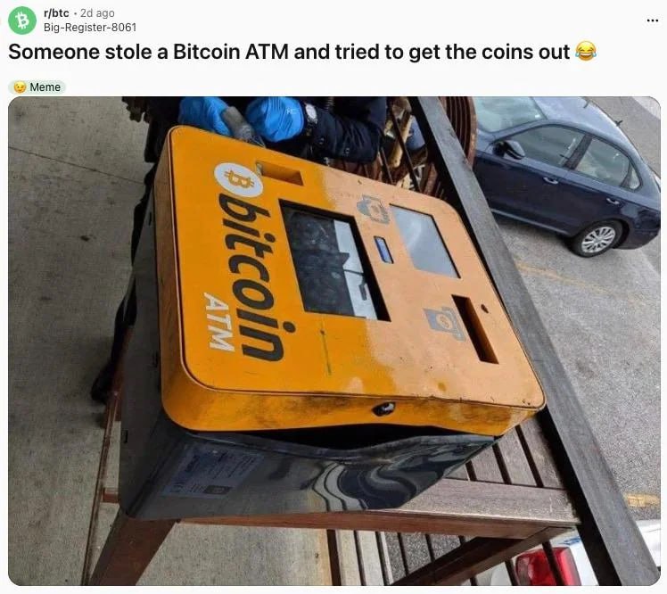 This meme features a photograph of a yellow Bitcoin ATM being tampered with by an individual wearing blue gloves, likely attempting to open it. The image is accompanied by a humorous caption that reads, 'Someone stole a Bitcoin ATM and tried to get the coins out 😂'. The ATM is placed on a wooden structure, with a dark-colored car visible in the background, suggesting an outdoor setting (possibly a parking lot). The humor stems from the irony of stealing a Bitcoin ATM to retrieve 'coins,' as Bitcoin is a digital currency with no physical form, making the theft attempt futile and comical.