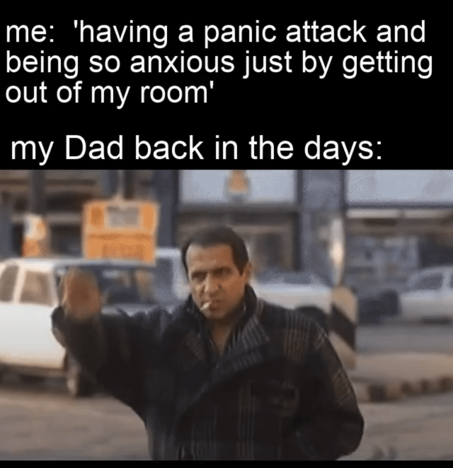 A meme featuring two text sections and an image. The top text reads 'me: 'having a panic attack and being so anxious just by getting out of my room'' followed by 'my Dad back in the days:' below which is a screenshot of a man in a dark jacket, smoking a cigarette, and waving dismissively in a parking lot with cars and industrial structures in the background. The humor arises from the stark contrast between the modern individual's anxiety over minor social interactions and the dad's casual, unbothered demeanor.