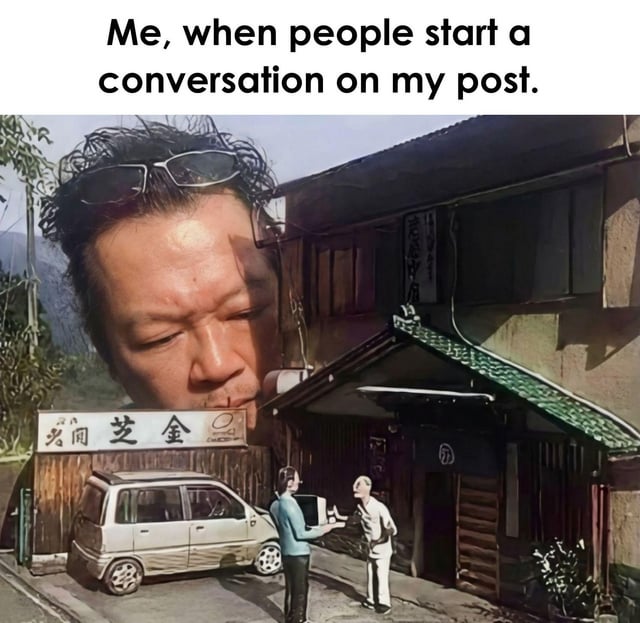 A meme consisting of a top text caption 'Me, when people start a conversation on my post' above a composite image. The image features a large, overlaid face of a real man with sunglasses resting on his head, positioned such that his face dominates the upper left portion of the scene. Below and behind his face is a background of a traditional-style building with wooden elements, a green-tiled awning, and a sign with Chinese characters. In the lower part of the background scene, two smaller figures (possibly animated or illustrated) stand near a silver parked car, appearing to engage in conversation. The juxtaposition of the large, neutral-faced man with the smaller interacting figures humorously conveys the poster's reaction to others initiating discussions on their social media post.