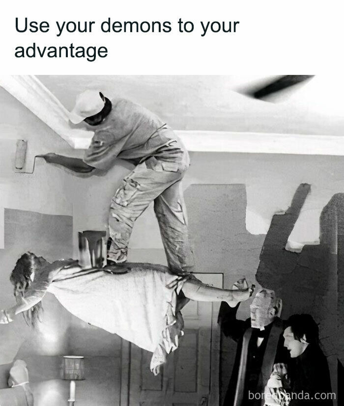 This is a black and white edited comedy meme that overlays a painter onto the iconic levitation scene from the 1973 horror film *The Exorcist*. The top text reads "Use your demons to your advantage", and the edit depicts the painter standing calmly on the possessed, levitating girl as a steady platform to paint the room wall, while the two priests who came to perform the exorcism stand to the side looking shocked. The joke plays on the concept of reframing negative or difficult situations, in this case a demonic possession, into something useful or beneficial for personal gain or productivity.