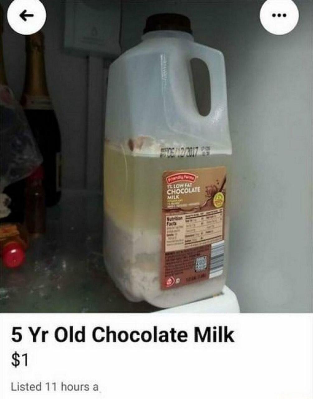 A photograph of a plastic jug of 'Hershey Farm 1% Low Fat Chocolate Milk' with a visible expiration date of December 2017, showing significant spoilage: the contents have separated into a yellowish liquid layer on top and a thick, solidified layer at the bottom. The jug is placed inside a refrigerator, surrounded by other indistinct items including bottles. At the bottom of the image, there is an overlaid text reading '5 Yr Old Chocolate Milk $1', humorously presenting the expired, spoiled milk as a for-sale item.
