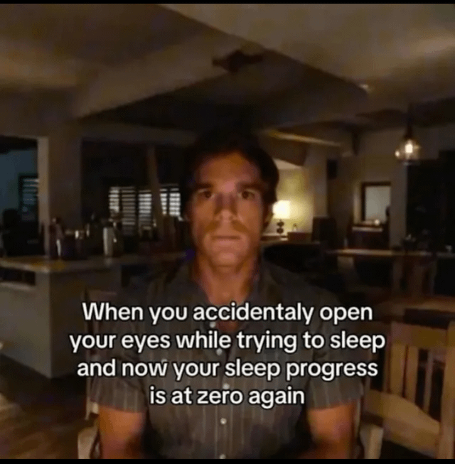 A meme featuring a man sitting in a dimly lit room (possibly a restaurant or home interior) with a neutral or slightly frustrated expression. The text overlay humorously captures the relatable experience of accidentally opening one's eyes while trying to sleep, resulting in the feeling that all prior sleep progress has been reset to zero.