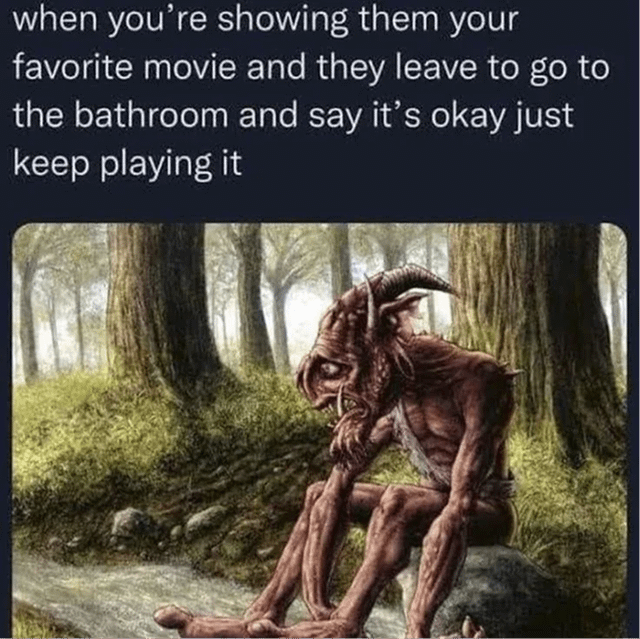 This meme is a relatable humor piece centered on the disappointment of sharing your favorite media with someone who interrupts the experience. The top text reads: "when you're showing them your favorite movie and they leave to go to the bathroom and say it's okay just keep playing it". Below the text is an image of a dejected, hunched goblin-like fantasy creature sitting alone on a rock in a dim forest, resting his head on his hand with a sad, thoughtful expression. The joke leans into the universal feeling of letdown when a shared, beloved moment is interrupted—even if the other person says it's fine, you feel lonely and deflated, with the sad creature visually embodying that quiet disappointment.