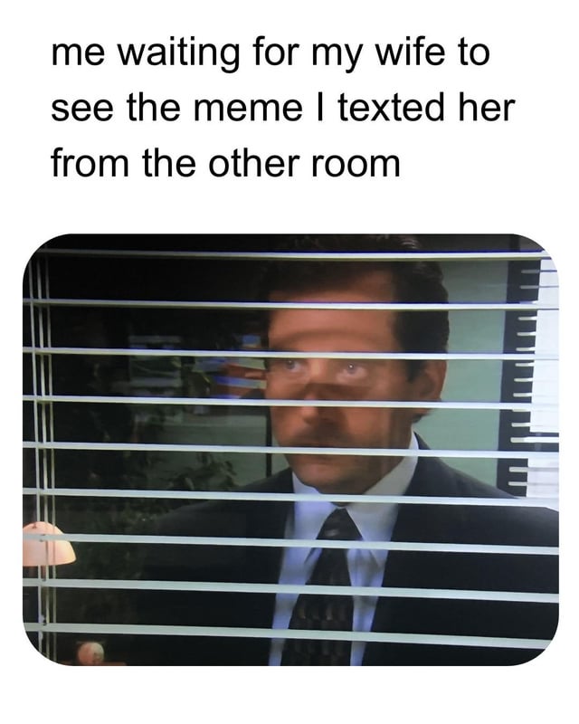 A meme featuring a top text caption and a screenshot of a man (Dr. Gregory House from the TV show 'House M.D.') peeking through horizontal window blinds with an intense, focused expression. The caption reads: 'me waiting for my wife to see the meme I texted her from the other room'. The humor stems from the relatable scenario of eagerly anticipating someone's reaction to a shared meme, exaggerated by the character's spy-like, overly serious posture, creating a funny contrast between the trivial situation and the intense visual.