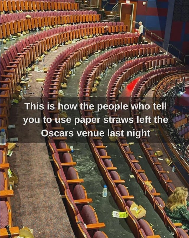 This meme uses a photograph of the post-Oscars Dolby Theatre venue, which is covered in plastic bottles, discarded food containers, and general trash across rows of red theater seats. Overlaid text reads: *"This is how the people who tell you to use paper straws left the Oscars venue last night"*, creating a satirical point about performative environmentalism and hypocrisy—calling out people who promote small eco-friendly gestures (like paper straws) but leave large amounts of plastic waste behind at a high-profile event. The image includes real people (event staff and attendees) in the scene, emphasizing the real-world mess left after the ceremony.