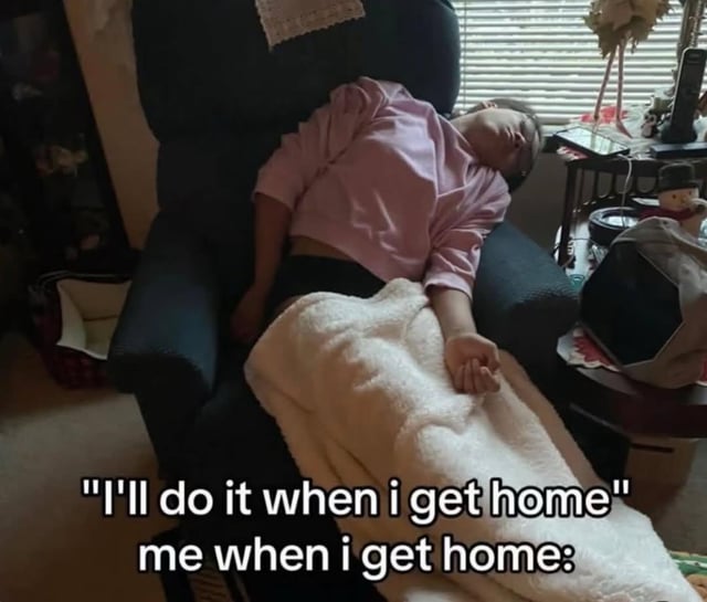 A meme featuring a person lying comfortably on a dark blue armchair, covered with a white fluffy blanket, appearing to be resting or asleep. The image has overlaid text that reads: 'I'll do it when i get home' followed by 'me when i get home:'. The humor stems from the relatable scenario of procrastinating tasks promised to be completed upon returning home, only to relax instead of taking action.