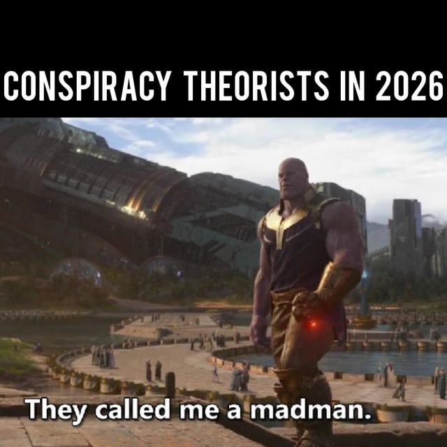 A meme featuring Thanos from the Marvel Cinematic Universe standing in a scenic outdoor setting with a large curved metallic structure and small figures in the background. Top text reads 'CONSPIRACY THEORISTS IN 2026' and bottom text 'They called me a madman,' humorously implying conspiracy theorists will be proven right by 2026.