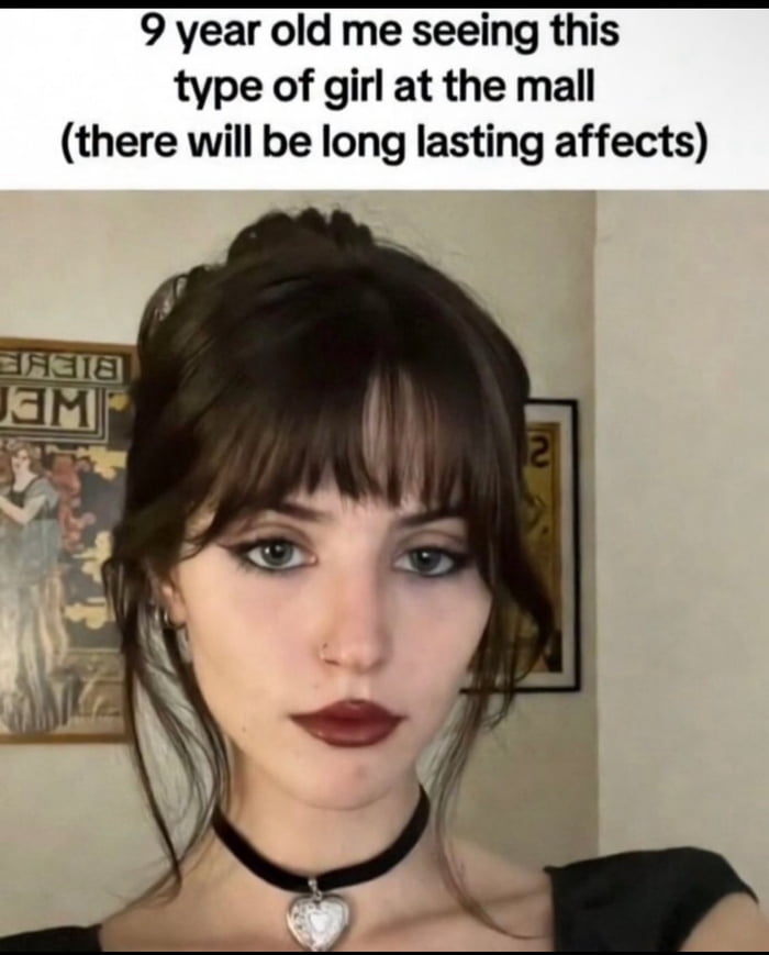 This meme consists of a top text caption placed above a selfie of a young woman with an alternative/goth aesthetic: she has dark brown hair with bangs styled in a half-updo, dark winged eyeliner, deep burgundy lipstick, a nose piercing, and wears a black velvet choker with a silver heart pendant. The text at the top reads "9 year old me seeing this type of girl at the mall (there will be long lasting affects)". The joke is relatable to many millennial and Gen Z people, referencing the formative, long-term impact that encountering cool alternative subculture figures in public as a child had on their later style preferences, identity, or early crush experiences.