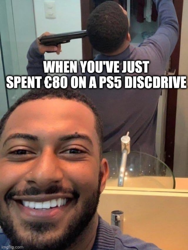 This is a reaction meme using a mirror selfie setup. In the foreground, a Black man grins widely with a bright, carefree expression directed at the camera. In the mirror reflection behind him, the same man is holding a handgun pressed to the back of his own head. Bold white overlaid text across the middle reads 'WHEN YOU'VE JUST SPENT €80 ON A PS5 DISCDRIVE'. The joke plays on the contrast between a fake outward happy facade and hidden inner turmoil, mocking people who pretend to be satisfied with their expensive purchase of the detachable PS5 disc drive add-on while secretly feeling deep regret for wasting money on the product.