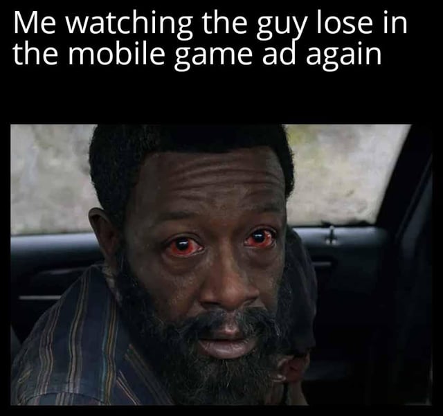 A meme featuring a top text caption 'Me watching the guy lose in the mobile game ad again' above a central image of a man with striking red eyes, displaying an intense, shocked expression while seated in a car interior. The meme humorously captures the relatable frustration of repeatedly encountering mobile game advertisements where the protagonist fails, using the character's exaggerated emotional state to amplify the reaction.