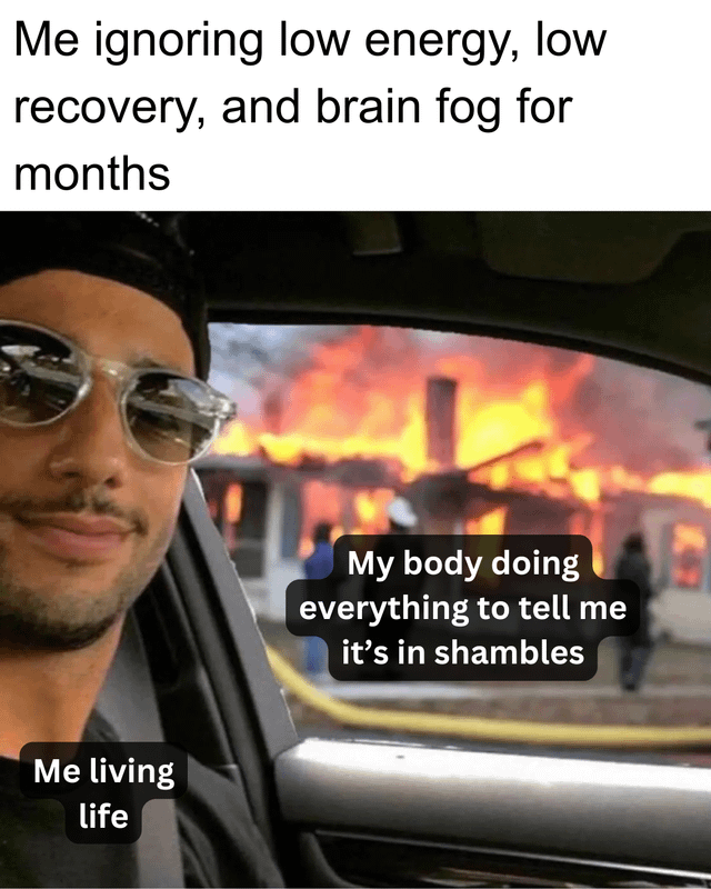 This is a relatable health meme that uses the popular viral 'calm selfie in front of a burning house' template. The meme jokes about how many people ignore persistent bad health symptoms like constant low energy, poor recovery, and brain fog for months, continuing to live life as normal while their body is already showing major signs that something is wrong, represented by the burning house in the background. It resonates with people who mistakenly wrote off these symptoms as just normal adulthood, matching the PSA context from the original post.