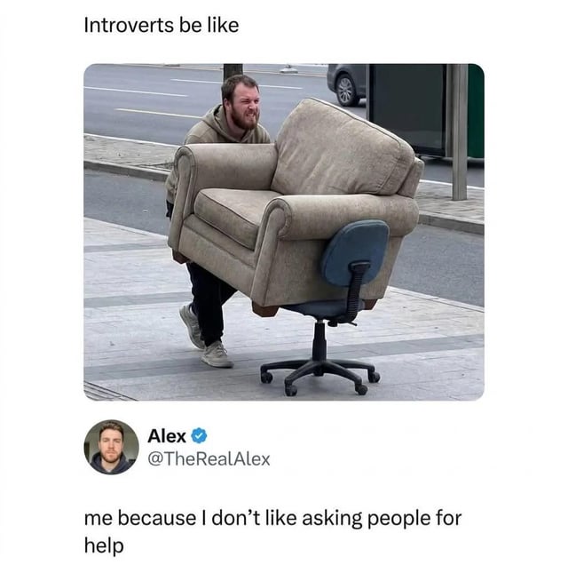 This meme opens with the top text 'Introverts be like', followed by a photograph of a man grimacing with effort as he carries a large, heavy upholstered armchair that has been placed directly on top of a standard rolling office chair, instead of asking another person to help him move the armchair. Below the photo is a verified Twitter/X post from user Alex @TheRealAlex with the caption 'me because I don't like asking people for help'. The joke exaggerates the common introverted or independently minded trait of going to absurdly inefficient, difficult lengths to avoid needing to request assistance from other people.