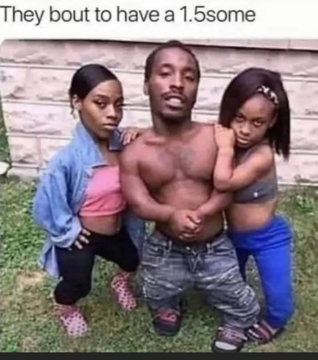 The meme shows three people posing outdoors on grass in front of a light stone wall. A shirtless man with dwarfism stands at the center, flanked by a woman in a pink crop top and denim jacket on his left, and a younger woman/girl in a grey crop top on his right. Text at the top reads "They bout to have a 1.5some". The crude, absurdist joke is a pun on terms for group sexual encounters like "threesome" (often shortened to 3some): it plays on the man's short stature to joke that he counts as half a person, resulting in the 1.5 number referenced in the original post's question about the math to get 1.5.