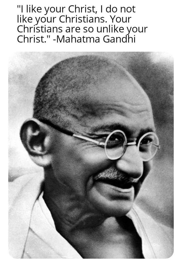 A black and white portrait photograph of Mahatma Gandhi, featuring a quote attributed to him: 'I like your Christ, I do not like your Christians. Your Christians are so unlike your Christ.' The image presents the quote in black text at the top, with Gandhi's smiling face below, creating a thought-provoking commentary on the contrast between religious figures and their followers.