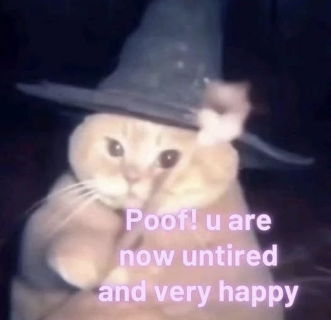 This is a low-resolution, softly blurry wholesome meme. It features a light orange domestic cat wearing a black pointed witch/wizard hat, set against a plain dark background. The cat looks directly at the viewer with wide, gentle dark eyes. Overlaid on the lower half of the image in rounded light pink text is the message: 'Poof! u are now untired and very happy', which acts as a whimsical magical blessing to remove the viewer's tiredness and give them joy. The overall vibe is warm, comforting, and playful.