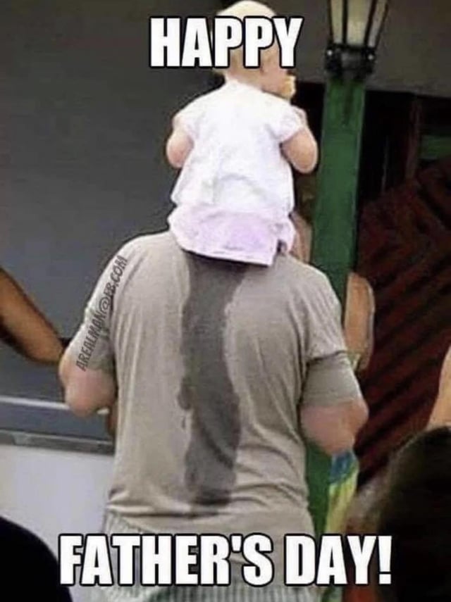 This is a humorous Father's Day meme shot from a back perspective. A father is carrying a young baby on his shoulders, and the baby has urinated, leaving a prominent dark wet stain running vertically down the back of the father's gray t-shirt. Bold white text with black outline is placed at the top reading "HAPPY" and at the bottom reading "FATHER'S DAY!". The meme lightheartedly jokes about the unglamorous, messy, and often unexpected realities of being a father caring for young children, creating a funny contrast between the cheerful holiday greeting and the awkward real-life situation.