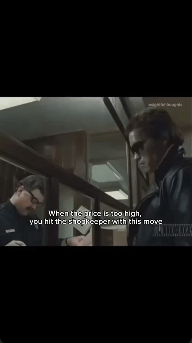 A screenshot from a movie scene depicting two individuals in a shop setting. One person, presumably a shopkeeper, stands behind a wooden counter writing on a piece of paper, while the other, a customer wearing a dark leather jacket, stands in front of the counter. Overlaid white text reads: 'When the price is too high, you hit the shopkeeper with this move,' framing the scene as a humorous suggestion for dealing with exorbitant prices. The shop interior includes wooden cabinets and a glass partition, contributing to a retro or classic store atmosphere.