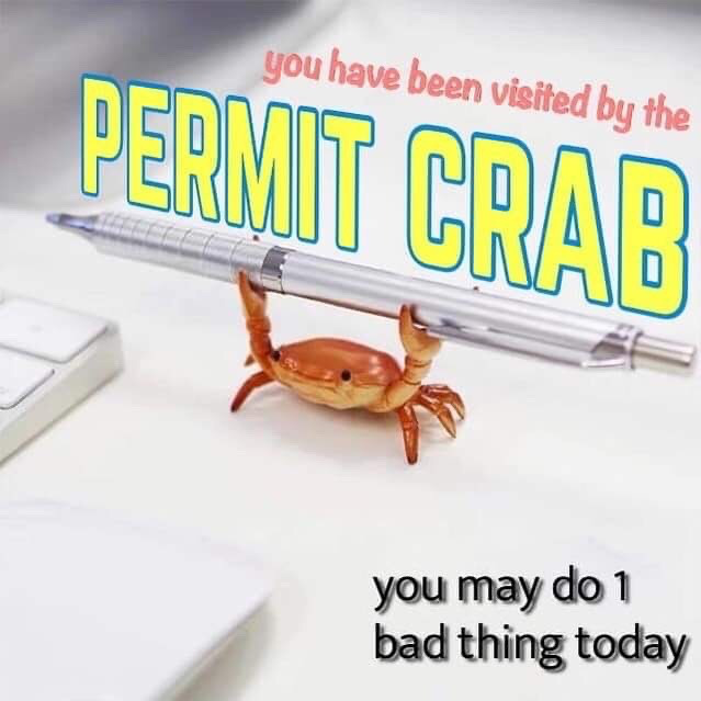 The meme features a small orange plastic crab desk toy, designed as a pen holder, standing on a white desk next to the edge of a white keyboard, holding a silver retractable pen aloft with its two front claws. Small pink text at the top reads 'you have been visited by the', followed by large bold yellow text with a blue outline stating 'PERMIT CRAB'. Black text in the bottom right corner says 'you may do 1 bad thing today'. The joke follows the common internet meme format of a character visiting the viewer to grant a boon, in this case lighthearted permission to commit one minor, harmless misbehavior without guilt.