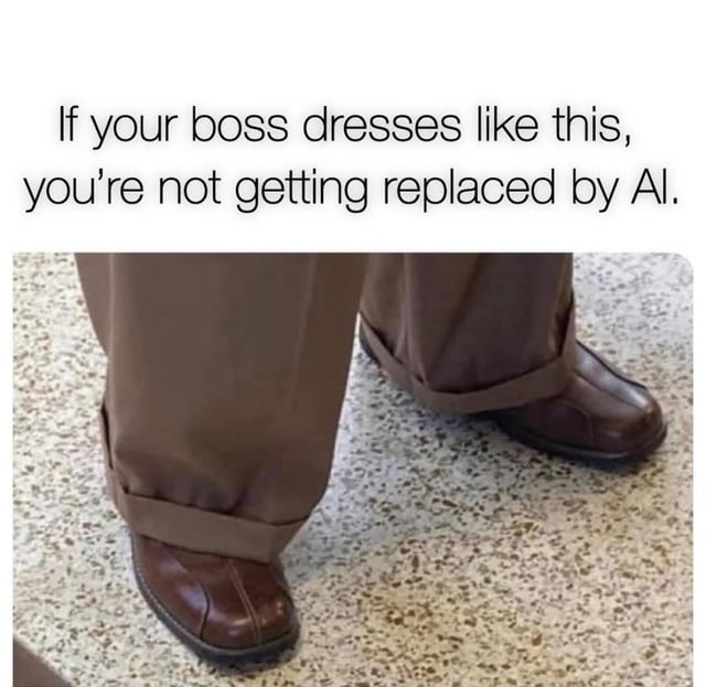 A meme featuring a top text overlay and a photograph. The text reads, 'If your boss dresses like this, you're not getting replaced by AI.' Below the text is a photograph of a person's lower legs and feet standing on a speckled (terrazzo or linoleum) floor. The individual is wearing brown pants rolled up at the ankles, paired with brown leather shoes. The humor hinges on the sarcastic implication that a boss with outdated, unfashionable attire is unlikely to be technologically advanced enough to replace employees with AI, thus reassuring the viewer about job security.