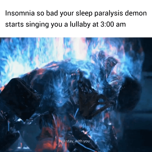 This meme consists of text paired with a shot of a fiery, demonic humanoid figure resembling Marvel's Ghost Rider, wreathed in blue and orange flames. The top text reads 'Insomnia so bad your sleep paralysis demon starts singing you a lullaby at 3:00 am', while subtitle text overlaid on the bottom of the image reads 'I'll stay, with you'. The joke subverts the common cultural perception of sleep paralysis demons as terrifying, harmful entities, instead humorously framing the demon as a caring figure that helps the insomniac fall asleep by singing a comforting lullaby.