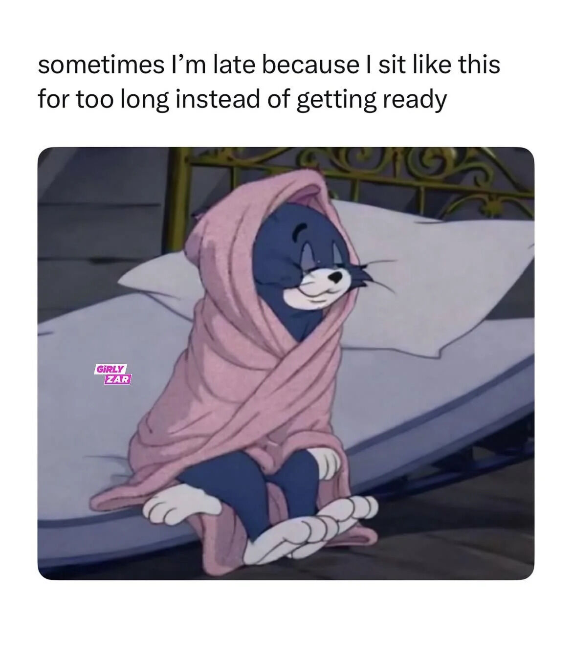 This is a relatable humorous meme that has text at the top, paired with a screenshot from the classic animated series Tom and Jerry. The top text states 'sometimes I’m late because I sit like this for too long instead of getting ready'. The visual below shows Tom the cat sitting on the edge of a bed, wrapped snugly in a soft pink blanket, with a drowsy, content, zoned-out half-smiling expression. The meme pokes fun at the common real-life experience of procrastinating getting ready to leave the house by staying comfortable and spacing out, which ends up making people late for their plans.
