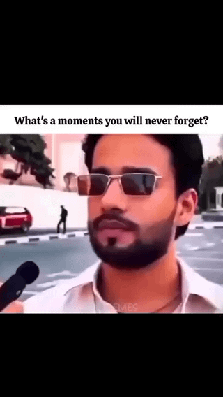 This meme uses a street interview setup format: the top text asks 'What's a moments you will never forget?' (with a minor grammatical error of using 'a moments' instead of 'a moment'), above footage of a man with a beard and thin rectangular sunglasses wearing a white collared shirt, standing outdoors on a street as a microphone is held up to him for an interview. The original title 'Lifetime trauma' implies the man is about to recount an extremely embarrassing, cringey, or humorously framed negatively memorable life event that counts as 'lifetime trauma' for comedic effect. The background shows a paved street, a white wall, a red parked car, a distant pedestrian, and trees.