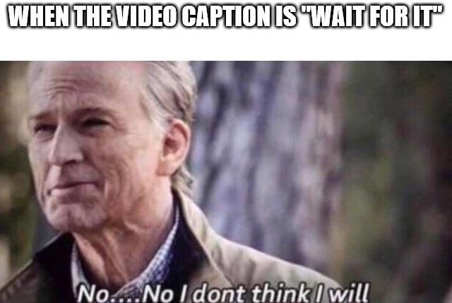 A meme featuring a screenshot of an older man with gray hair, wearing a brown jacket over a checkered shirt, standing outdoors with a blurred tree trunk and greenery in the background. The top text, in bold uppercase letters, reads 'WHEN THE VIDEO CAPTION IS "WAIT FOR IT"', while the bottom text (appearing as the character's dialogue) states 'No... No I don't think I will'. The meme humorously conveys reluctance to endure lengthy buildup in videos that use 'Wait for it' captions, often leading to underwhelming payoffs.