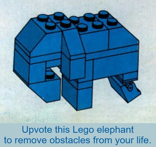 A meme featuring a small elephant sculpture constructed from blue Lego bricks. The elephant is made up of various blue Lego pieces, with a blocky body, trunk, and legs. Below the Lego elephant, there is a blue banner containing the text: 'Upvote this Lego elephant to remove obstacles from your life.' The image has a simple, light background, making the blue Lego elephant the focal point. The humor stems from the playful superstition of upvoting an inanimate Lego structure to achieve a positive real-life outcome, a common trope in internet memes to encourage user engagement.
