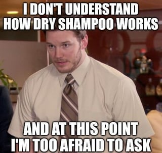 This is a single-panel reaction meme featuring a still of the character Andy Dwyer, played by actor Chris Pratt, from the US sitcom *Parks and Recreation*. He is depicted standing in an office environment, with a confused, awkward, and hesitant expression. Bold white all-caps text is overlaid at the top and bottom of the image: the top line reads 'I DON'T UNDERSTAND HOW DRY SHAMPOO WORKS', and the bottom line reads 'AND AT THIS POINT I'M TOO AFRAID TO ASK'. The meme conveys the relatable, humorous feeling of being confused by a common, widely-used product but being too embarrassed to ask for an explanation, for fear of seeming ignorant.