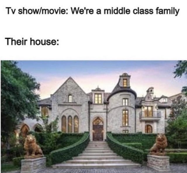A meme featuring two lines of text at the top: 'Tv show/movie: We're a middle class family' followed by 'Their house:', beneath which is a photograph of an extremely large, luxurious mansion. The mansion has stone architecture, twin lion statues flanking the entrance stairs, well-trimmed hedges, and a grand doorway with arched windows, creating a humorous contrast between the claim of being middle class and the opulent housing, satirizing the common trope in TV shows and movies where supposedly middle-class families live in unrealistic luxury.