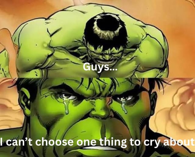 A two-panel meme featuring the Hulk from Marvel Comics. The top panel shows a close-up of Hulk's muscular head with a smaller, distressed Hulk face embedded in his forehead, accompanied by the text 'Guys...'. The bottom panel is an extreme close-up of Hulk's face with large tears streaming down his green cheeks, paired with the text 'I can’t choose one thing to cry about'. The background throughout is a fiery orange hue, enhancing the emotional intensity. The meme humorously depicts the feeling of being overwhelmed by multiple stressors or problems, making it relatable to those experiencing anxiety from having too many concerns to focus on a single issue.
