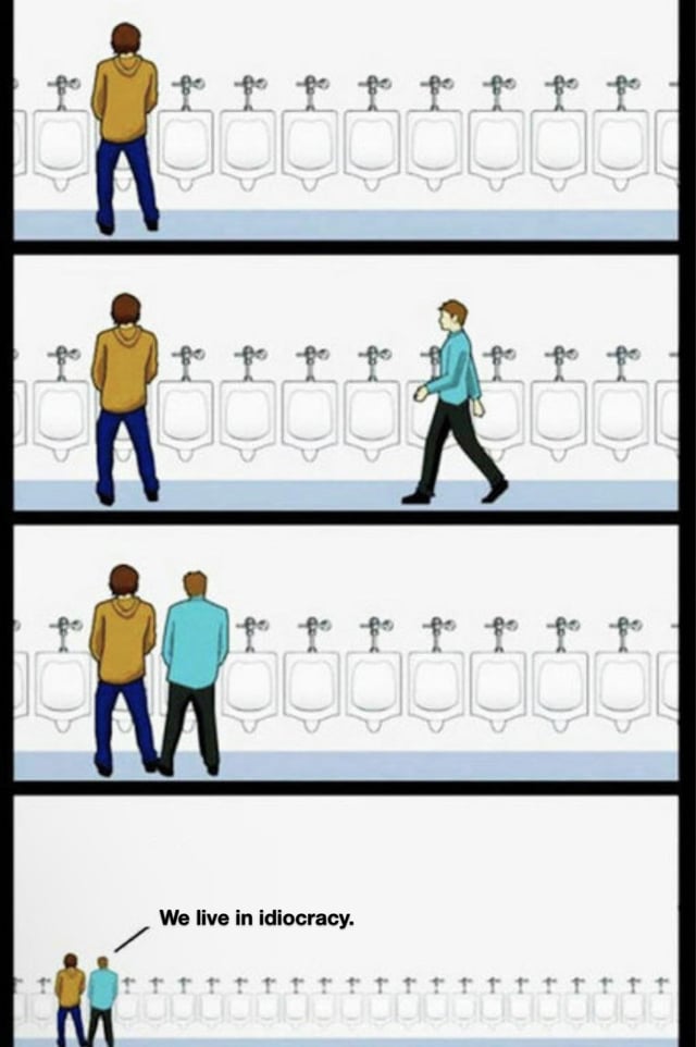 This is a 4-panel illustrated meme centered on unspoken men's public restroom etiquette. Panel 1 shows a man in a yellow hoodie standing alone at a urinal in a bathroom with a long line of empty urinals to his right. Panel 2 shows a second man in a light blue shirt walking toward the row of urinals. Panel 3 shows the second man choosing to stand directly at the urinal immediately adjacent to the first man, completely ignoring the widely accepted unwritten rule of leaving at least one empty urinal between two people using the restroom. Panel 4 zooms out to reveal the row of urinals is extremely long, with dozens of completely empty urinals available elsewhere, alongside a text caption pointing to the two men that reads 'We live in idiocracy.' The joke exaggerates the frustration of seeing someone ignore a small but nearly universal social norm, framing the minor faux pas as evidence that society is declining into foolishness.