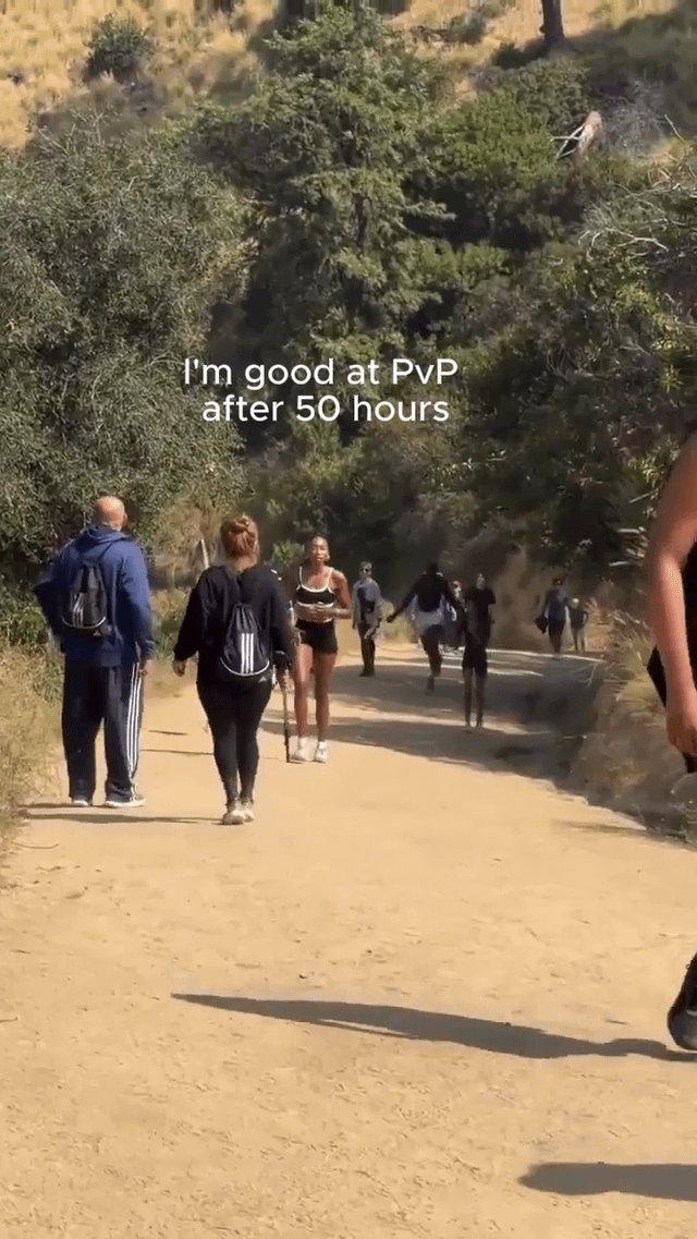This meme uses footage of a dirt hiking trail to make a relatable gaming joke. Slow, casual walkers on the left side of the path represent a new player who believes they are skilled at PvP (player versus player) combat after only 50 hours of gameplay. In the background, a group of people are sprinting aggressively towards the walkers, representing far more experienced, veteran PvP players who vastly outperform the overconfident new player. The humor comes from mocking the common experience of new players overestimating their skill level before encountering much more experienced opponents.