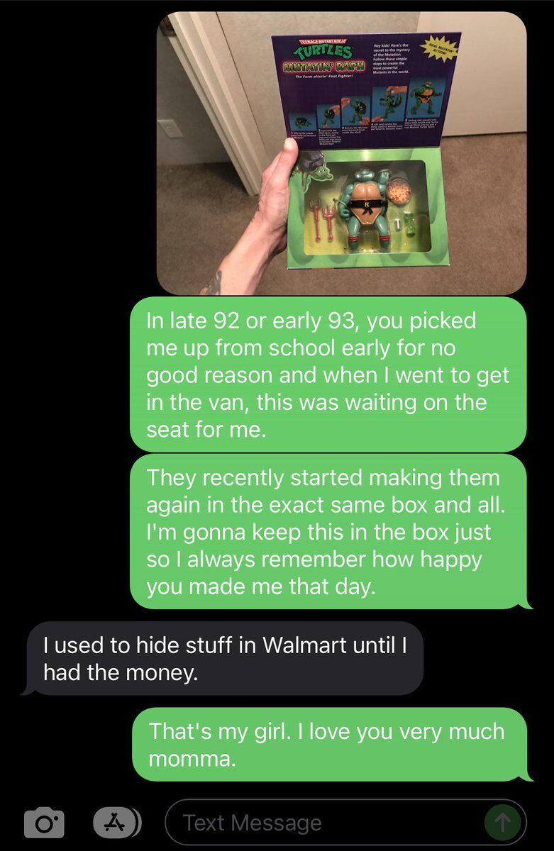 This image is a screenshot of a heartfelt text message conversation between an adult son and his mother. At the top of the screenshot is a photo of an opened, reissued Mutatin' Raph (Raphael) Teenage Mutant Ninja Turtles action figure in its original-style packaging, held by the son's hand. In the conversation, the son shares that back in late 1992 or early 1993, his mother picked him up early from school unexpectedly and surprised him with this exact toy, which was waiting for him on the van seat. He explains that toy companies have started re-releasing this toy with identical packaging, and he will keep it in the box to always remember how happy his mom made him that day. The mother replies, revealing that she used to hide the toy at Walmart until she had saved up enough money to buy it. The son responds with affection, telling his mom 'That's my girl. I love you very much momma.' The interaction is a warm, wholesome reminder of loving parental gestures and cherished childhood memories.
