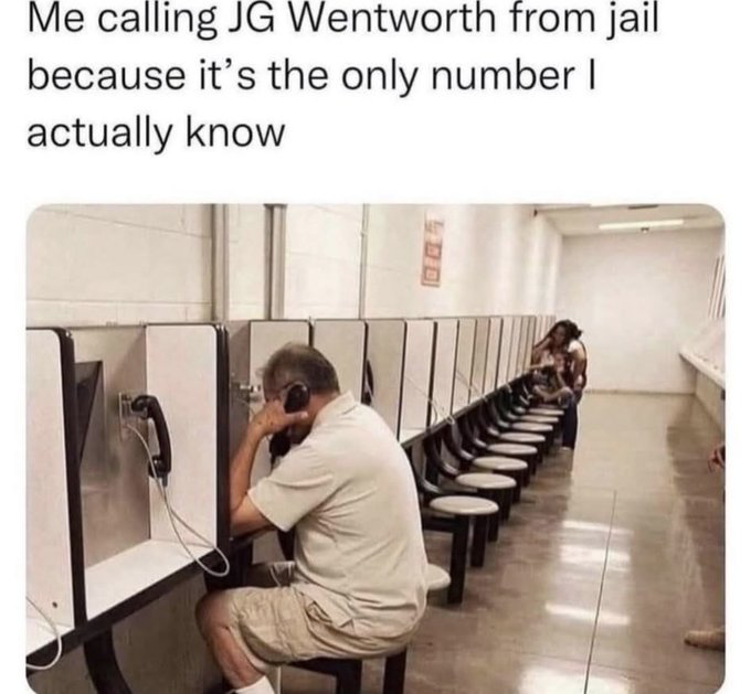 This is a single panel meme featuring a photograph of a middle-aged man sitting at a row of partitioned jail phone booths holding a phone receiver to his ear, with other people using phone booths further down the corridor. The text at the top reads 'Me calling JG Wentworth from jail because it's the only number I actually know'. The humor comes from the fact that JG Wentworth is a U.S. financial services company famous for extremely ubiquitous, frequently aired TV ads that prominently feature their phone number, to the point that many U.S. residents have the number memorized even if they have no use for the company's services, leading to the absurd relatable scenario of an incarcerated person only having that number memorized to call.