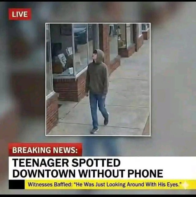 A satirical fake news screenshot featuring a 'breaking news' story about a teenager spotted downtown without a phone. The image shows a photograph of a young person walking on a sidewalk, looking around, with a 'LIVE' banner in the top left corner. Below the image, bold text reads 'BREAKING NEWS: TEENAGER SPOTTED DOWNTOWN WITHOUT PHONE' followed by a subheading: 'Witnesses Baffled: "He Was Just Looking Around With His Eyes."' The meme humorously exaggerates how unusual it has become for teenagers to be without their phones.