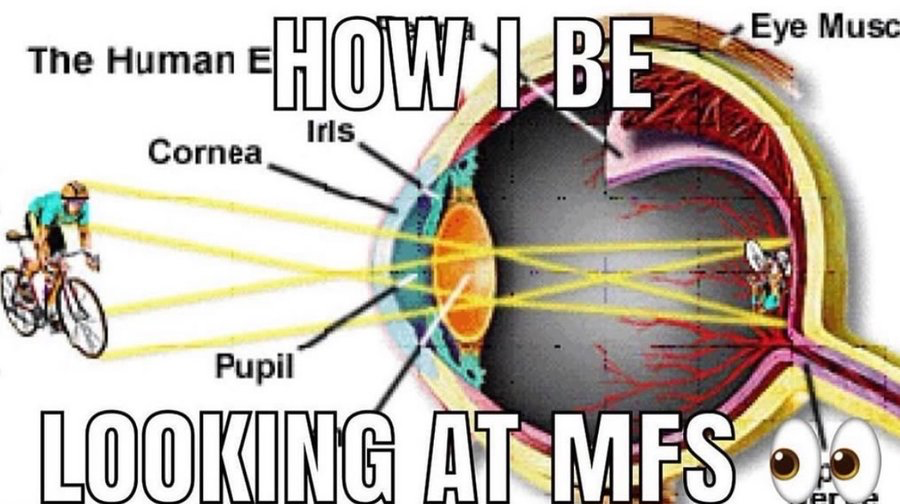 This is a humorous edited meme based on a standard cross-sectional educational diagram of the human eye. Original anatomical labels for parts including the Cornea, Iris, Pupil, and Eye Muscle are partially visible. Large text overlays read 'HOW I BE' at the top and 'LOOKING AT MFS' at the bottom. Instead of standard light rays focusing on the retina, the edit depicts a person riding a bicycle as the external visual stimulus, with light rays projecting an identical tiny version of the cyclist sitting inside the eye against the retina. A pair of cartoon googly eye emojis are placed at the bottom right corner. The joke exaggerates the experience of staring intently or fixating on another person, implying the person you are looking at is effectively just present inside your field of vision permanently.