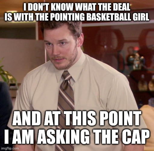 This meme features a screenshot of the character Andy Dwyer (played by Chris Pratt) from the US sitcom *Parks and Recreation*, displaying a confused, perplexed expression. White bold meme text is overlaid at the top and bottom: the top line reads 'I DON'T KNOW WHAT THE DEAL IS WITH THE POINTING BASKETBALL GIRL', while the bottom line reads 'AND AT THIS POINT I AM ASKING THE CAP'. The joke relies on a homophonic pun: 'asking the cap' sounds nearly identical to the common phrase 'too afraid to ask', and references the widely circulated 'pointing basketball girl' viral meme, mocking people who are confused by ubiquitous online meme references they do not recognize.