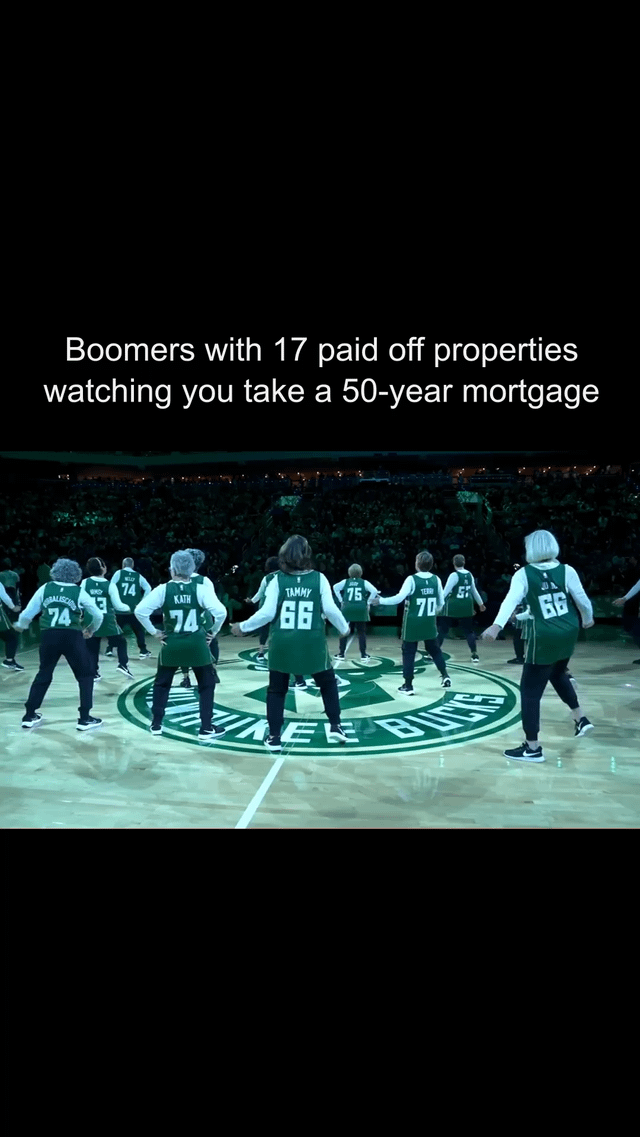 The image depicts a group of elderly individuals (referred to as 'boomers') wearing green basketball jerseys with numbers like 66, 70, 74, and 75, dancing in a coordinated formation on a basketball court featuring the Milwaukee Bucks logo. The background shows a stadium filled with spectators. A prominent text overlay at the top reads: 'Boomers with 17 paid off properties watching you take a 50-year mortgage.' The meme uses the joyful, celebratory dance of the elderly group to satirically comment on generational wealth disparity, humorously implying that older generations with significant property assets are amused by younger generations' struggles with long-term mortgages.