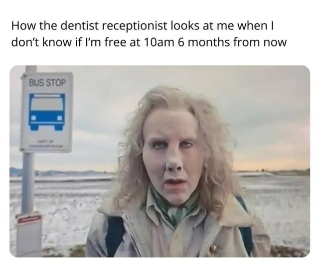 A meme with a top text overlay reading: 'How the dentist receptionist looks at me when I don't know if I'm free at 10am 6 months from now'. Below is an image of a person with curly blonde hair, wearing a neutral-colored jacket, standing near a bus stop sign featuring a blue bus icon. The background shows a cloudy sky and an open landscape. The person has a confused, slightly skeptical expression, humorously exaggerating the relatable frustration of committing to far-future appointments, a common everyday struggle.