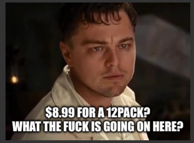 A meme featuring a screenshot of Leonardo DiCaprio from the movie *Titanic*, capturing his character with a shocked and confused expression. Overlaid in bold white text is the caption: "$8.99 FOR A 12PACK? WHAT THE FUCK IS GOING ON HERE?" The meme humorously uses DiCaprio's iconic surprised look to exaggerate reactions to the perceived high cost of a 12-pack of soda.