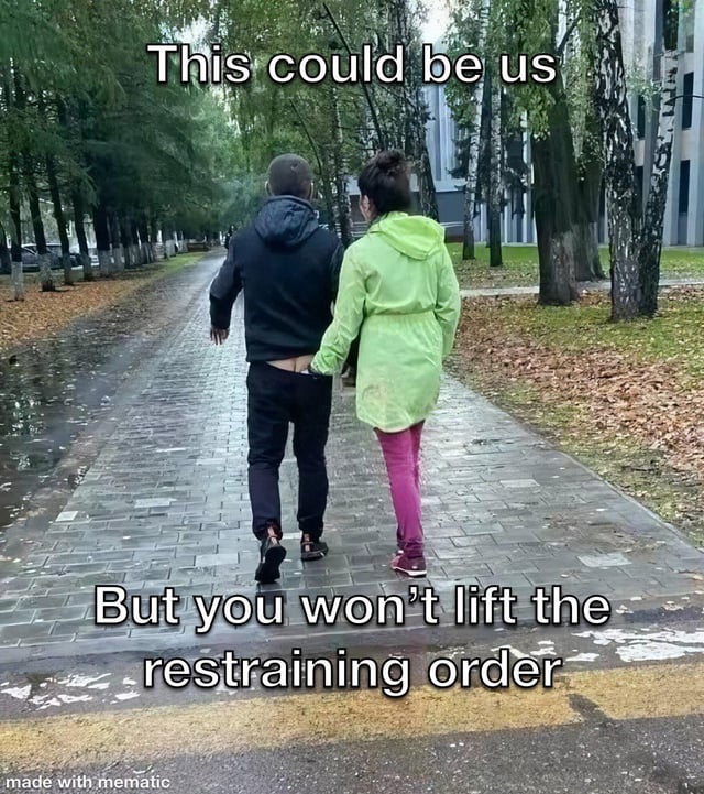 A meme depicting two individuals walking hand in hand on a wet, tree-lined brick path. The top text overlay reads 'This could be us' while the bottom text humorously contrasts with 'But you won't lift the restraining order,' creating a sarcastic twist on a seemingly romantic scene by referencing a legal restraining order. The image has a 'made with mematic' watermark at the bottom, indicating it was created using the Mematic mobile editing app.