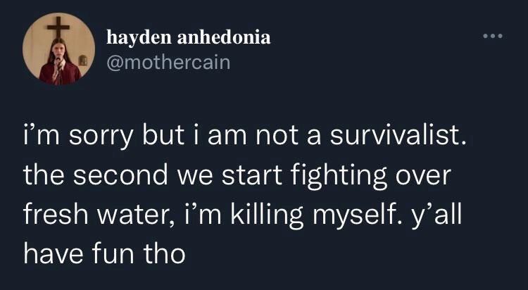 This image is a screenshot of a public post from the X (formerly Twitter) platform. The post is made by user @mothercain, with display name Hayden Anhedonia, who is the professional musician known as Ethel Cain. The post text jokes about not being interested in survivalism, stating that if an apocalyptic scenario ever happens where people need to fight over fresh water, the poster will choose to opt out of survival entirely rather than participate, while wishing others who do participate fun. The user's profile picture shows them in a dark red robe holding a microphone, standing in front of a wooden cross, matching their signature gothic religious aesthetic.