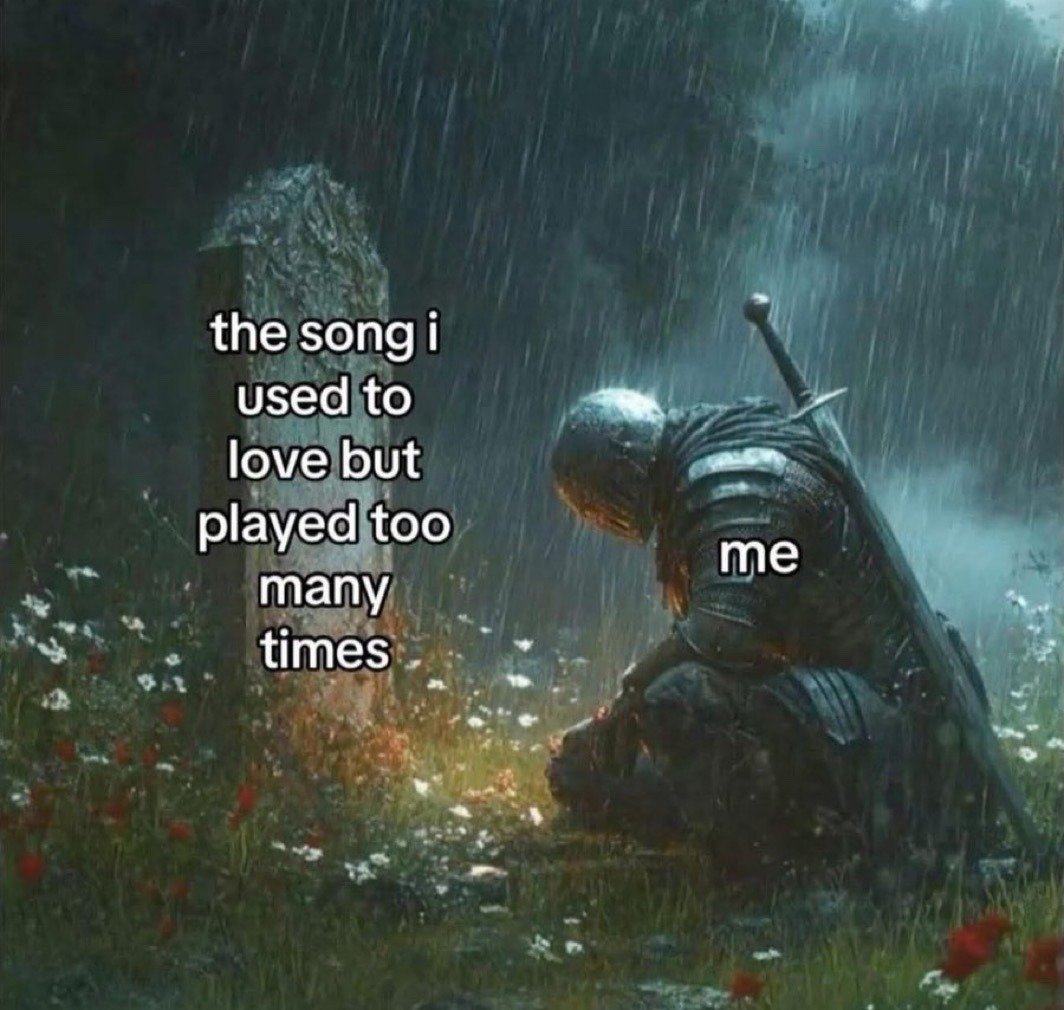 This is a relatable humor meme that pairs a somber dark fantasy illustration with lighthearted everyday commentary. The scene depicts a fully armored medieval knight kneeling with his head bowed in the rain next to a weathered gravestone, set in a grassy graveyard dotted with small red and white wildflowers. Text overlaid on the gravestone reads 'the song i used to love but played too many times', while text on the knight's back is labeled 'me'. The meme jokes about the common experience of ruining a once beloved song by listening to it so frequently that it no longer feels special, framing this minor disappointment as a devastating loss worthy of dramatic mourning.